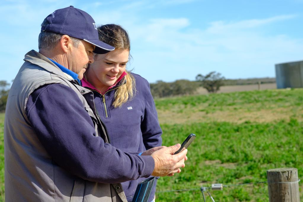 Farmers looking at Datamars app